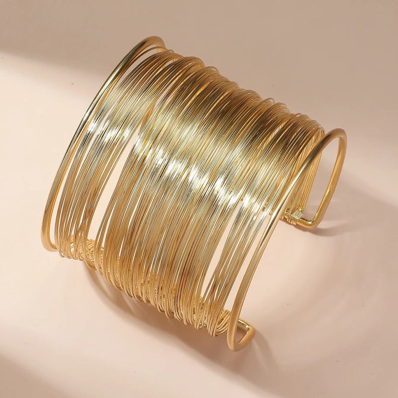 Open bracelet fitting with spiral in gold