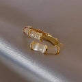 Luxurious adjustable ring with white opal stones in gold