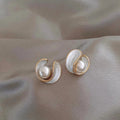 Luxurious earrings with white opal and pearls in gold
