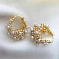 Earrings in the form of circles with a vintage design in gold and pearls