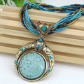 Vintage necklace with ethnic pendant of green crystal – Bronze