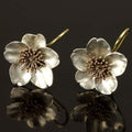 Vintage earrings in silver and gold with floral design